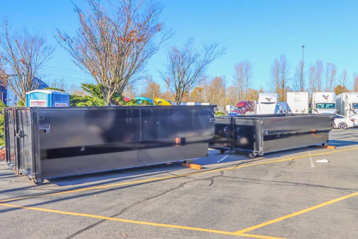 Professional dumpster rental service with roll-off container on residential driveway in Fridley